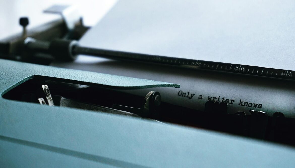 close up photography of typewriter with only a writer knows text on printer paper