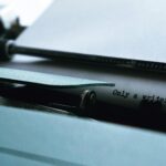 close up photography of typewriter with only a writer knows text on printer paper